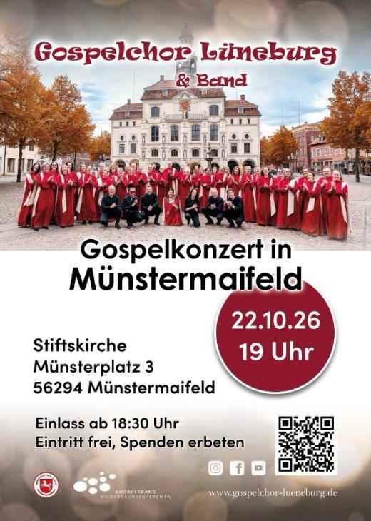 Man sieht das Plakat zum KOnzert des Gospelchors Lüneburg am 22.10.2026. Zu sehen ist der rot gekleidete Chor vor einem historischen Gebäude, rechts und links Bäume mit herbstlich gefärbtem Laub