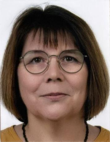 Man sieht das Porträt einer Frau mit brünettem Haar und Brille